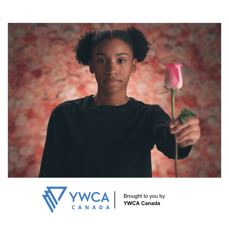 Young woman holding a single pink rose.