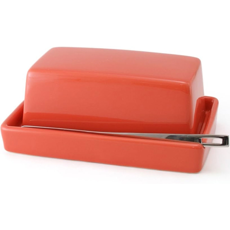 A canteloupe orange butter dish with a small matching spreading knife.