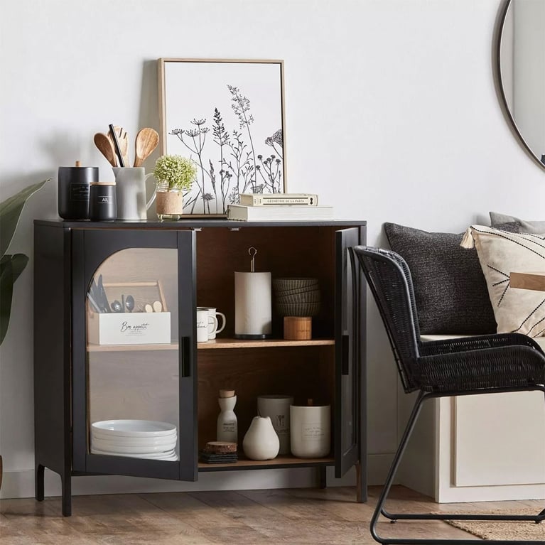 A black buffet with glass doors filled with white plates and other minimalist kitchenware in a post about best black friday deals canada.