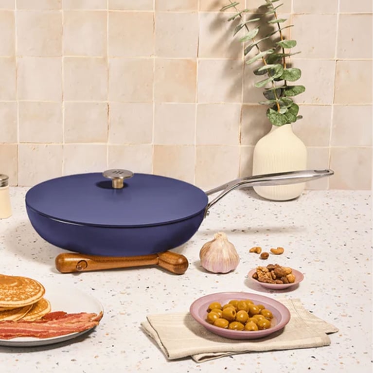 A bright blue frying pan on a counter next to some pancakes and bacon in a post about best black friday deals canada.