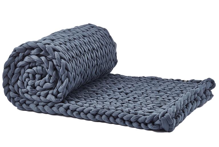 A blue Silk & Snow Hand-Knitted 15-Pound Weighted Blanket for an article about the best self-care gifts for pampering for the holidays.