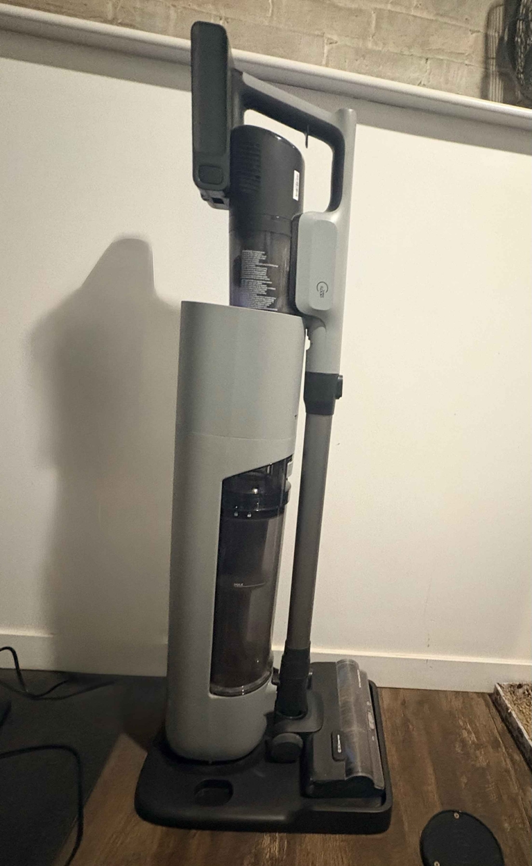 A tineco stick vacuum in its charging dock for a post on best stick vacuum dog.