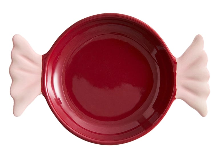 A photo of a pink and red H&M Home Candy-Shaped Serving Plate for an article about the best stocking stuffers ideas for the holidays.