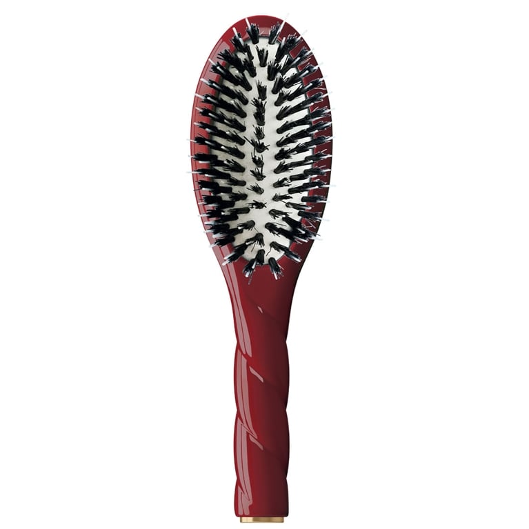 A red La Bonne Brosse: N.02 Small Care & Detangling Hair Brush for an article about the best stocking stuffers ideas for the holidays.