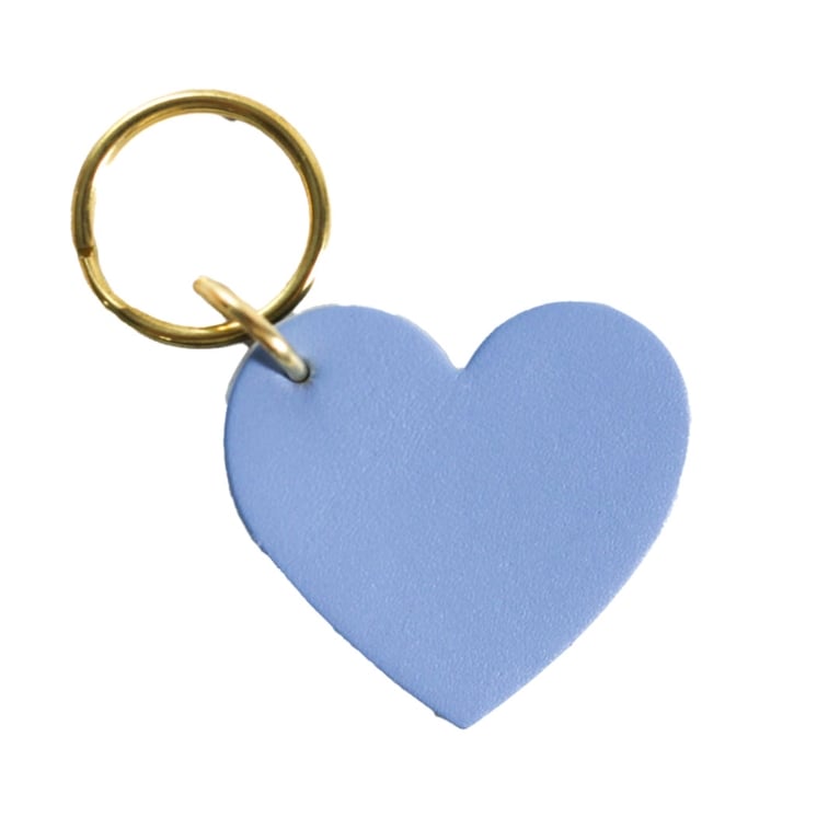 A blue heart-shaped Small Hours Studio Key Tag for an article about the best stocking stuffers ideas for the holidays.