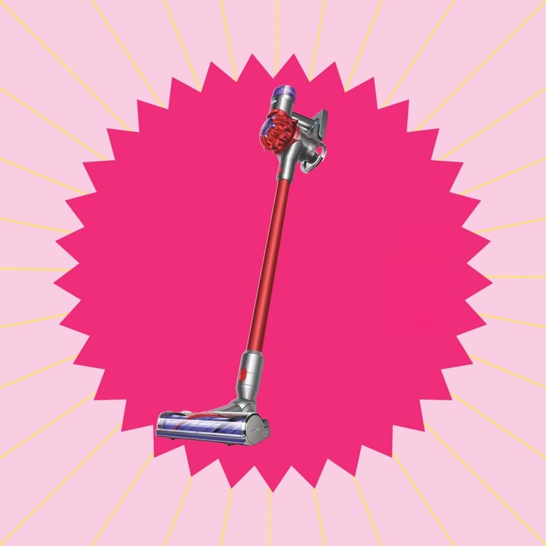 A Dyson stick vacuum in a pink graphic starburst for a post on best stick vacuums dog.