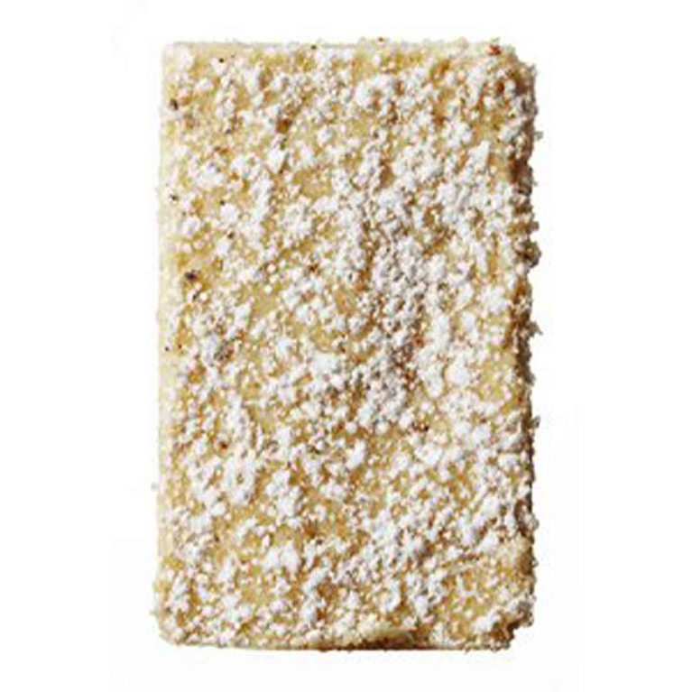 A square eggnog sugar cookie dusted with icing sugar.