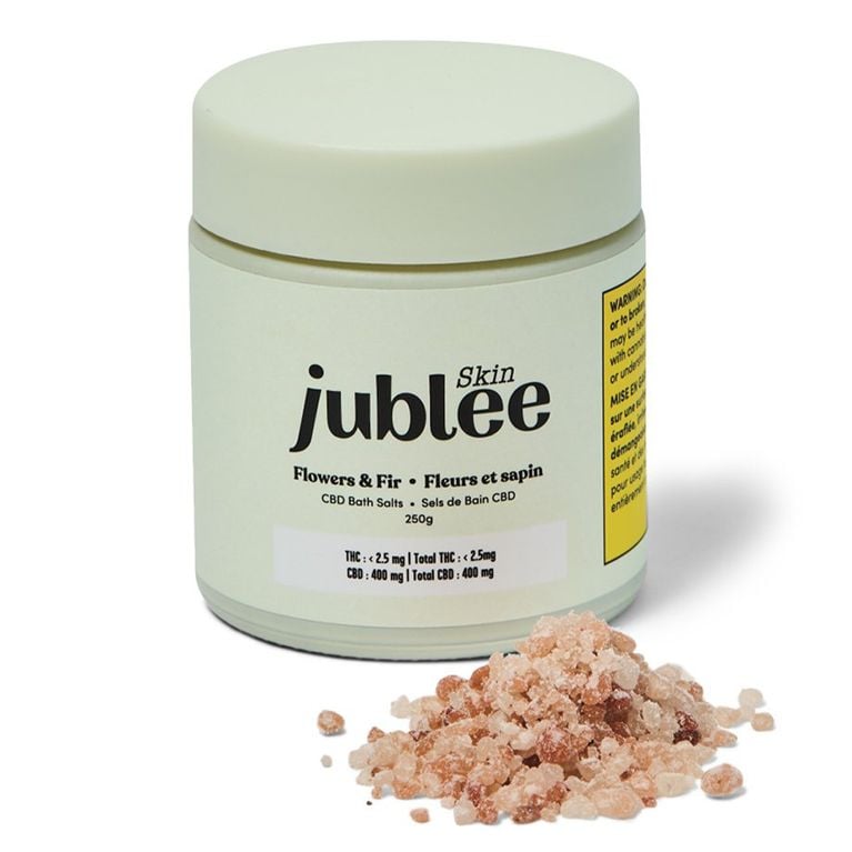 A white canister of pink bath salts in a post about best fitness gifts.