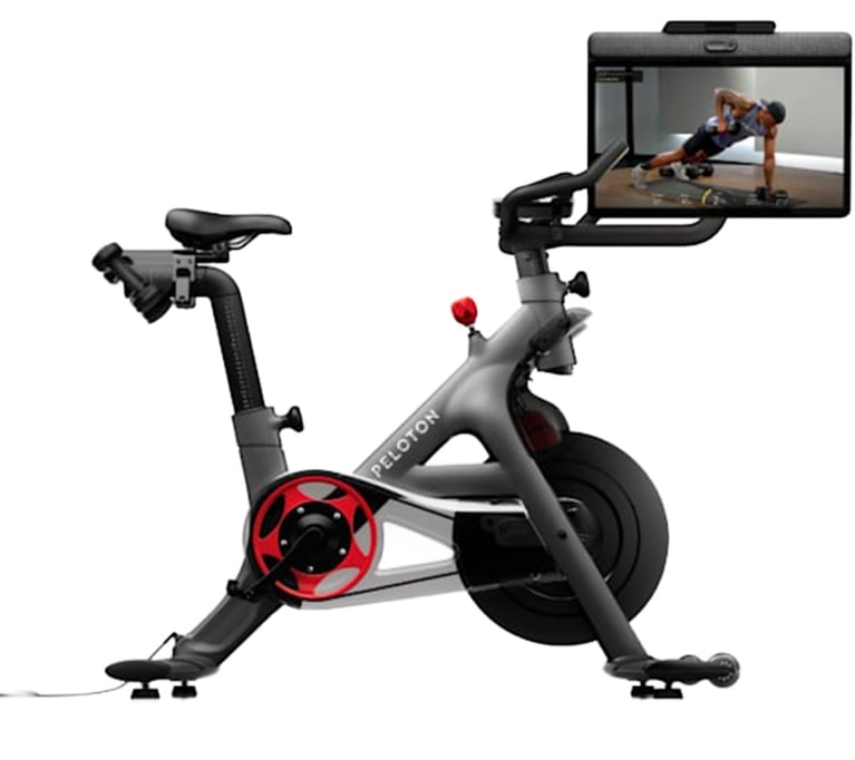 A Peloton bike+ with a swivel screen in a post about best fitness gifts.