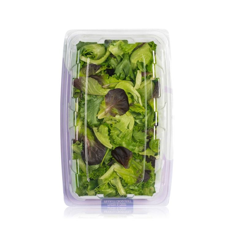 Top-down view of an open clear plastic container filled with Haven Greens Trillium Blend salad mix, showing the mix of bright green and darker red-leaf lettuce.