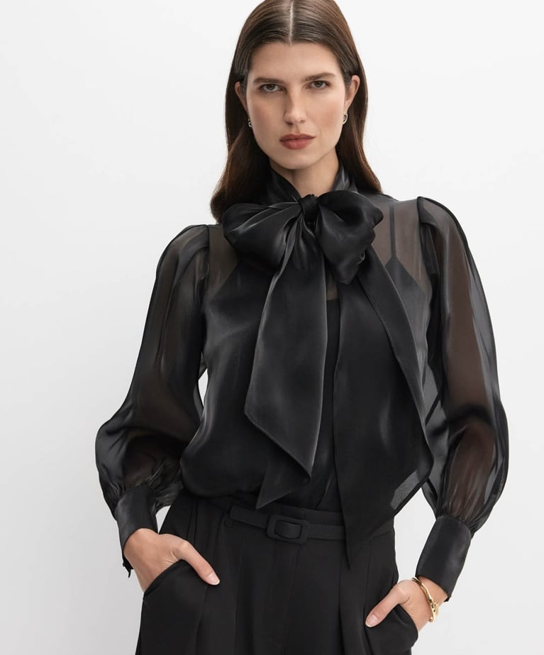 A model wearing an organza bow blouse from the Melanie Lyne holiday collection.