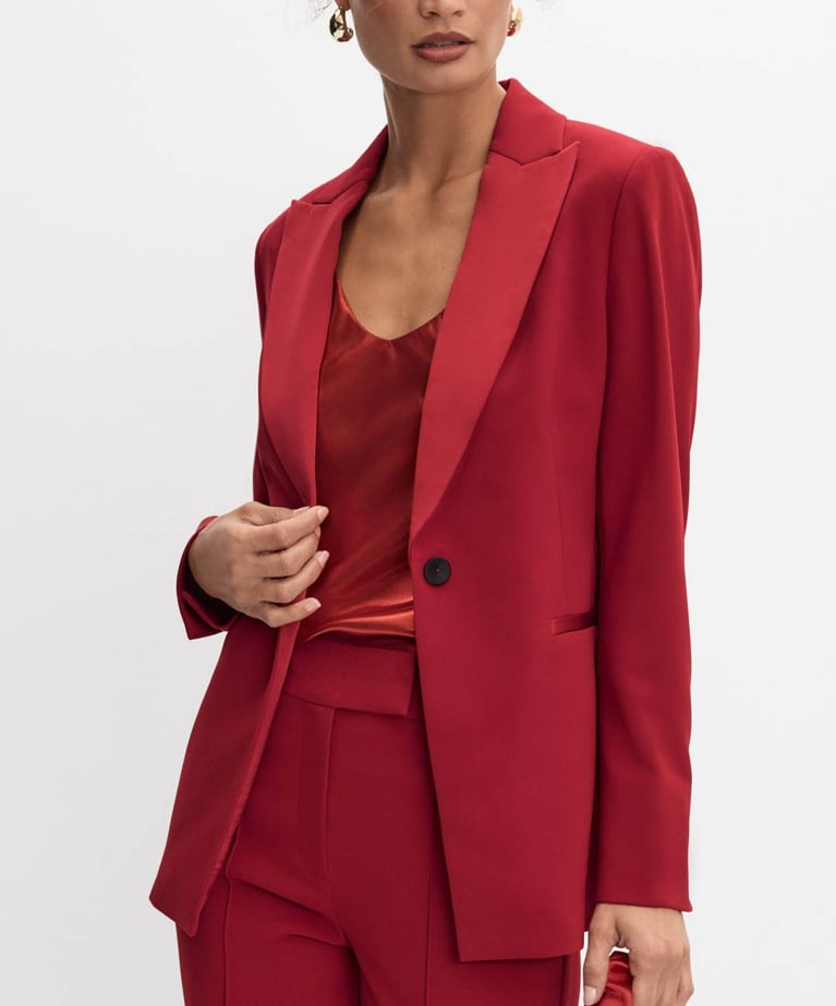 A model wearing a red blazer from the Melanie Lyne holiday collection.