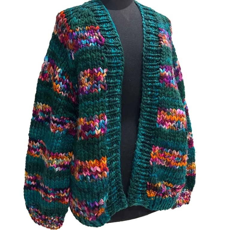A chunky knit green cardigam with rainbow stripes fom the nurse who knits at the one of a kind christmas show.