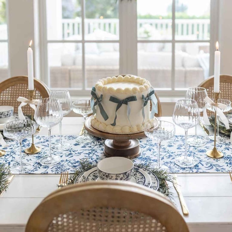 Fraiche wine and cocktail glasses on a table with cake for a post on the best under $50 budget holiday gifts