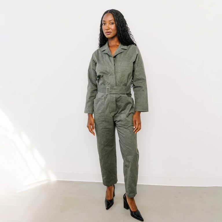 A model wearing a green Horses Atelier jumpsuit for an article about the best purchases our editors made in December 2025.