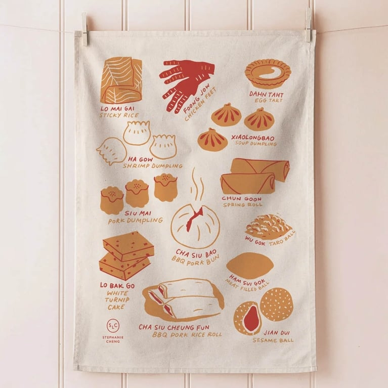 Photo of a linen tea towel with illustrations of dim sum.