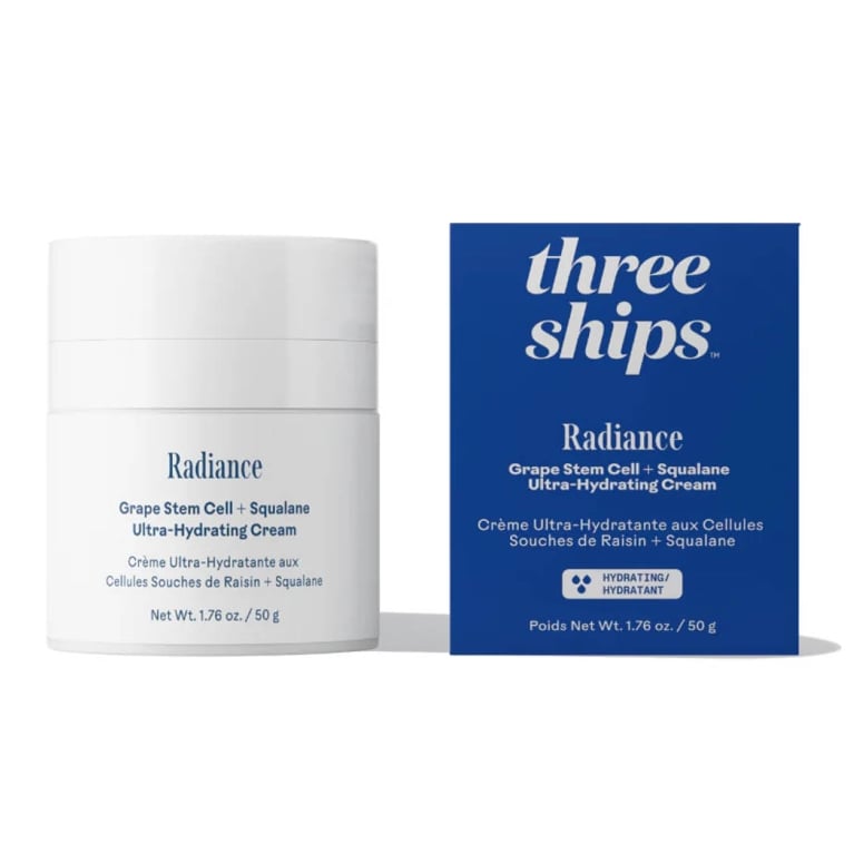 Photo of a jar of face cream, next to a blue packaging box.