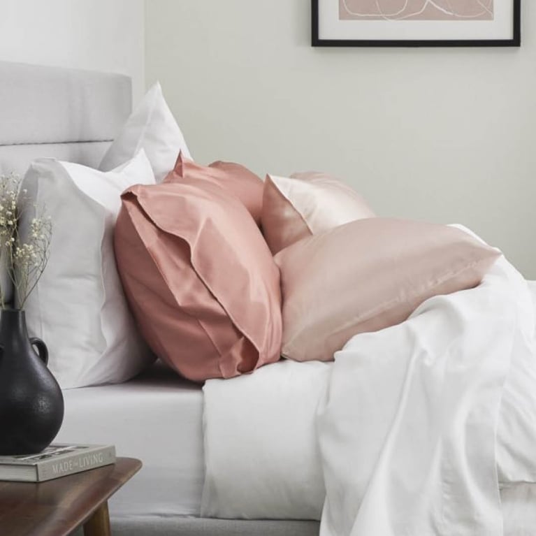 A pink Silk & Snow Silk Pillowcase on a bed for an article about what our editors want for Valentine's Day.