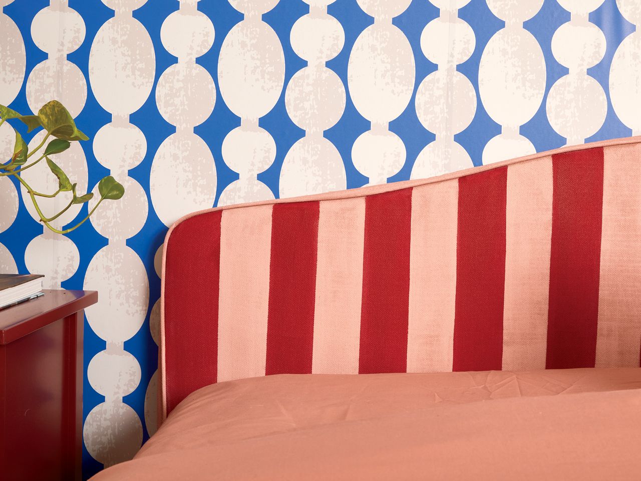 A striped painted bed frame by Decor expert Alexandra Gater for an article about easy DIY home decor projects.