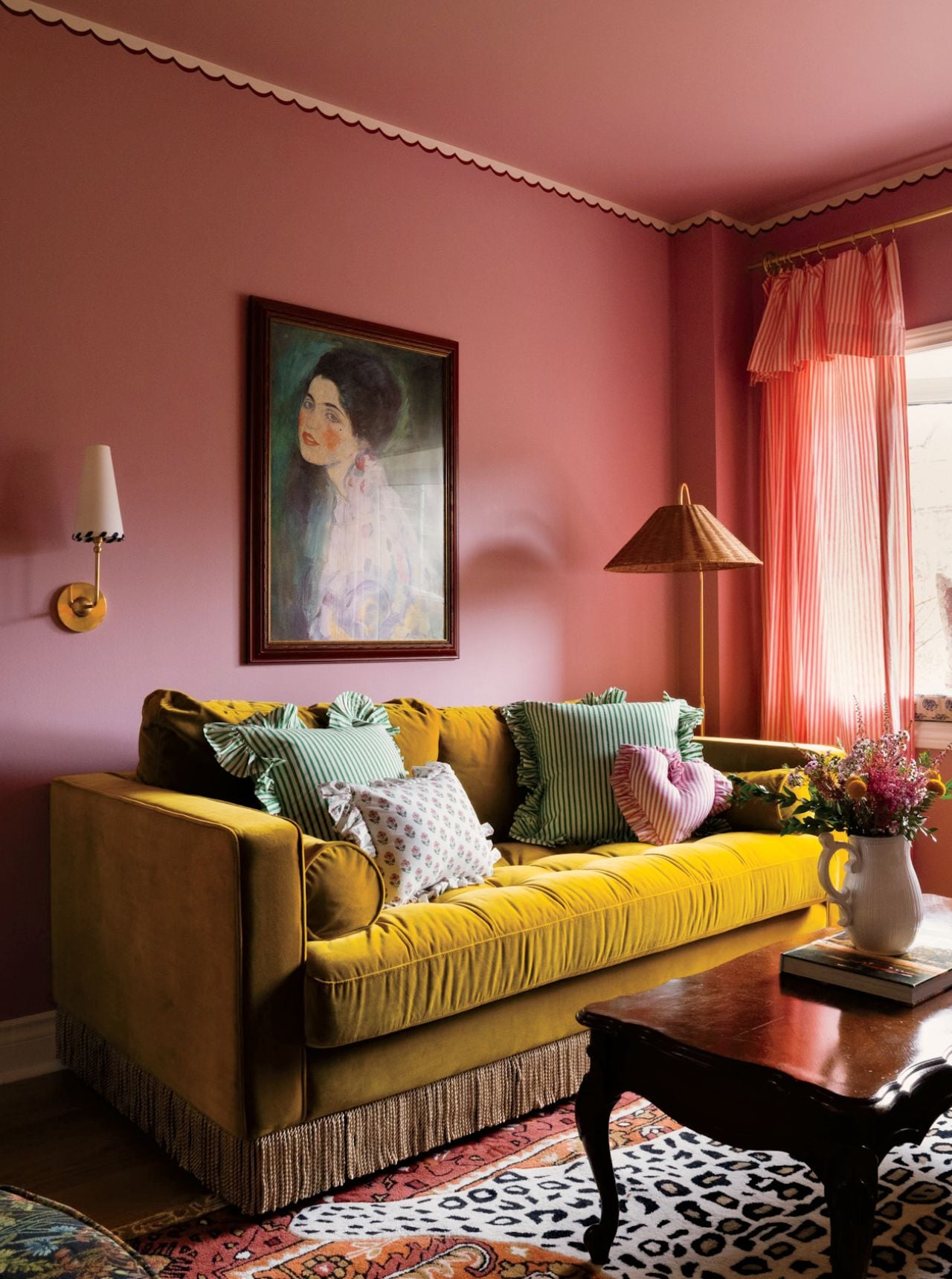 A wallpaper trip and fringed sofa in a maximalist living room by decor expert Alexandra Gater for an article about easy DIY home decor projects.