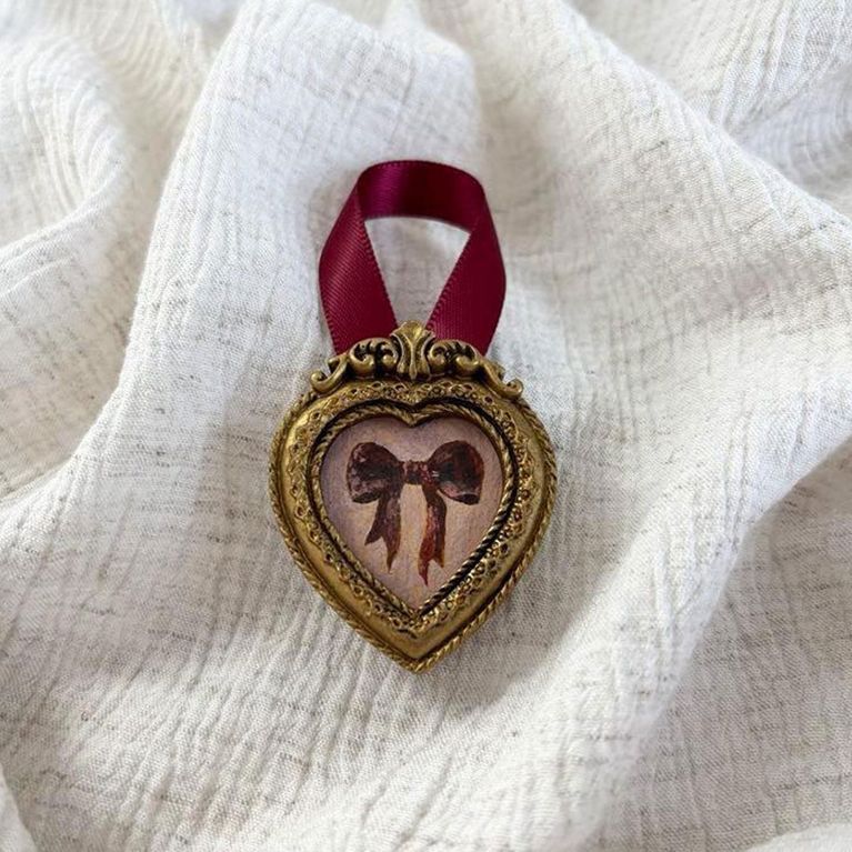 A tiny bow painting with a velvet ribbon from Melissa Mary Jenkins for an article about Etsy breakup registry gifts.