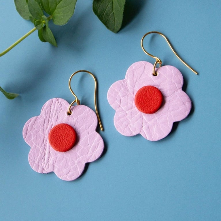 A pair of pink and red leather flower earrings from Scandinazn for an article about Etsy breakup registry gifts.