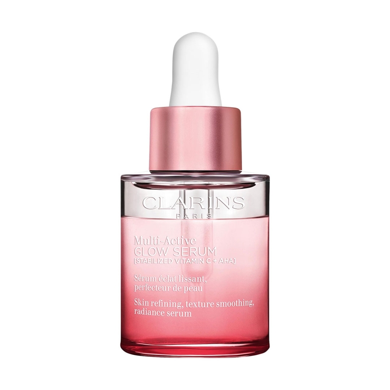 A bottle of Clarins Multi-Active Glow Serum for and article about how to wash your face according to a dermatologist.