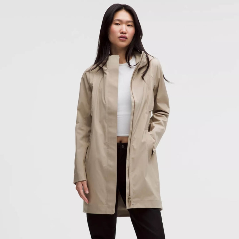 A model wearing a beige Lululemon rain jacket for an article about our editors best purchases in March 2026.