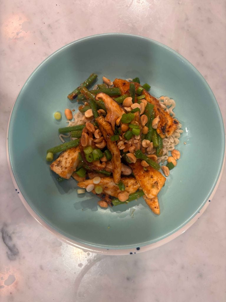 A turquoise bowl filled with cheap tofu stir-fry, a.k.a. Chatelaine's Crispy Tofu Stir-Fry With Peanut Sauce.