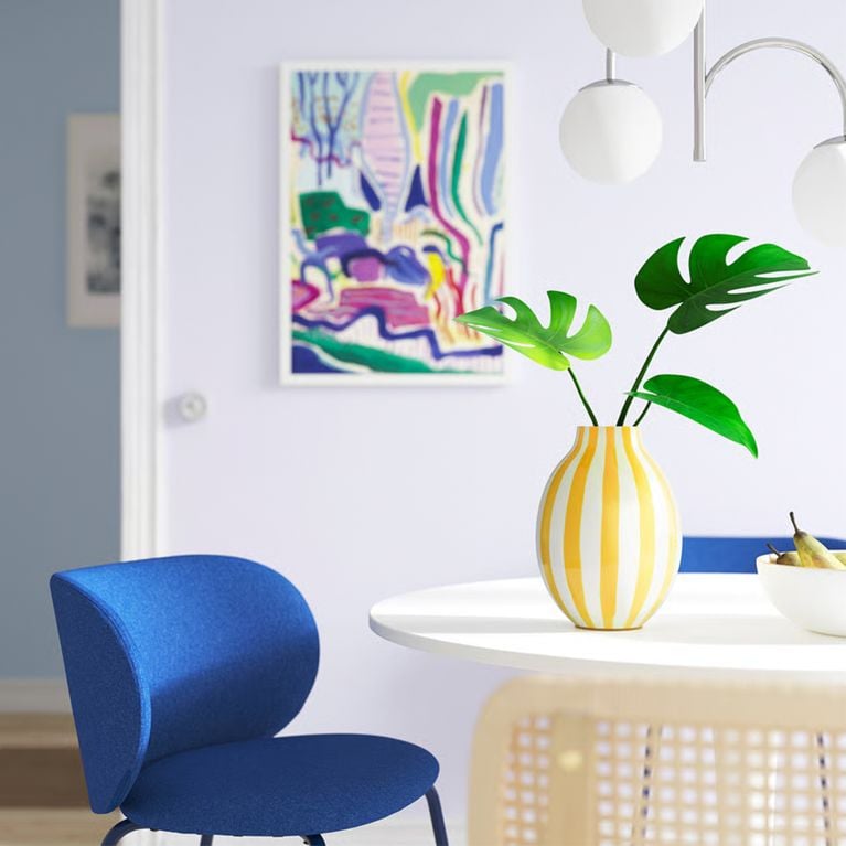 A photo of the BLODBJÖRK vase, in yellow and white, from IKEA's Easter collection.