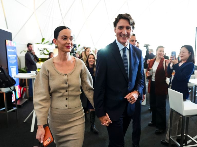 A photo of a woman in a beige sweater and skirt and a man in a navy suit used in a post on justin trudeau katy perry age.
