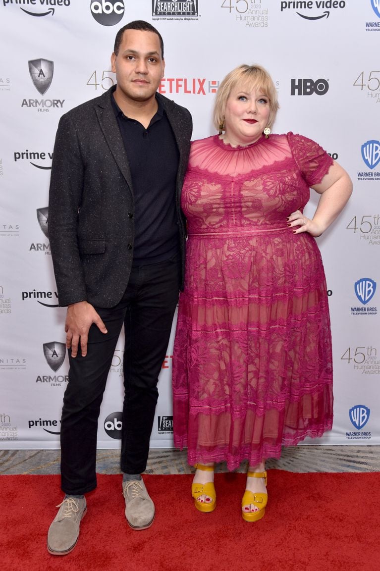 A photo of a woman in a lacy raspberry pink dress and a man in a. black suit on the red carpet, used in a post on lindy west and ployamory.