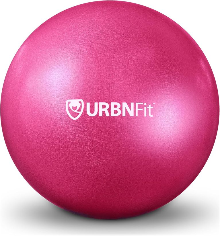 A pink Pilates ball used in a post on how to do Pilates at home.