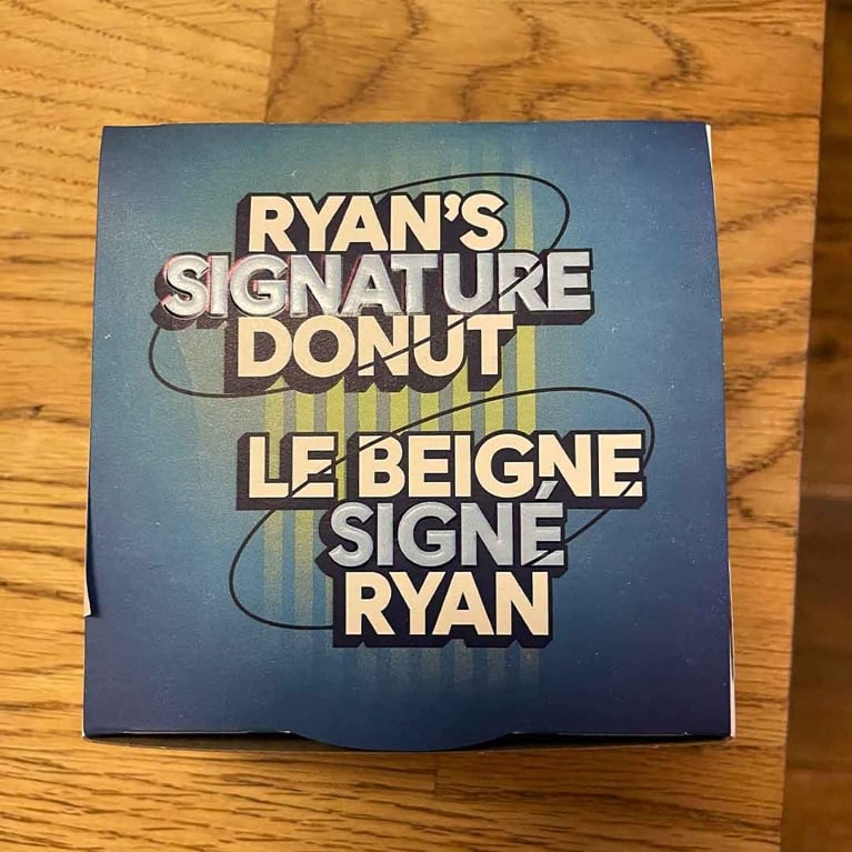 A blue box with the text Ryan's Signature Donut on it, as part of the Tim Hortons Ryan Reynolds donut collab.