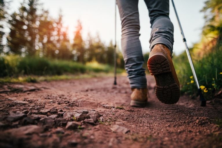 A pair of legs walking on a trail in a post about alpine divorce.