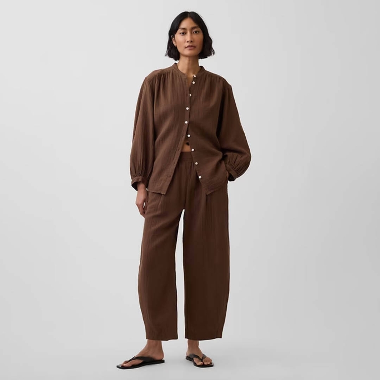 A model wearing Gap Gauze Easy Barrel Pants in the shade cool brown for an article about the best purchases editors picked in April 2026