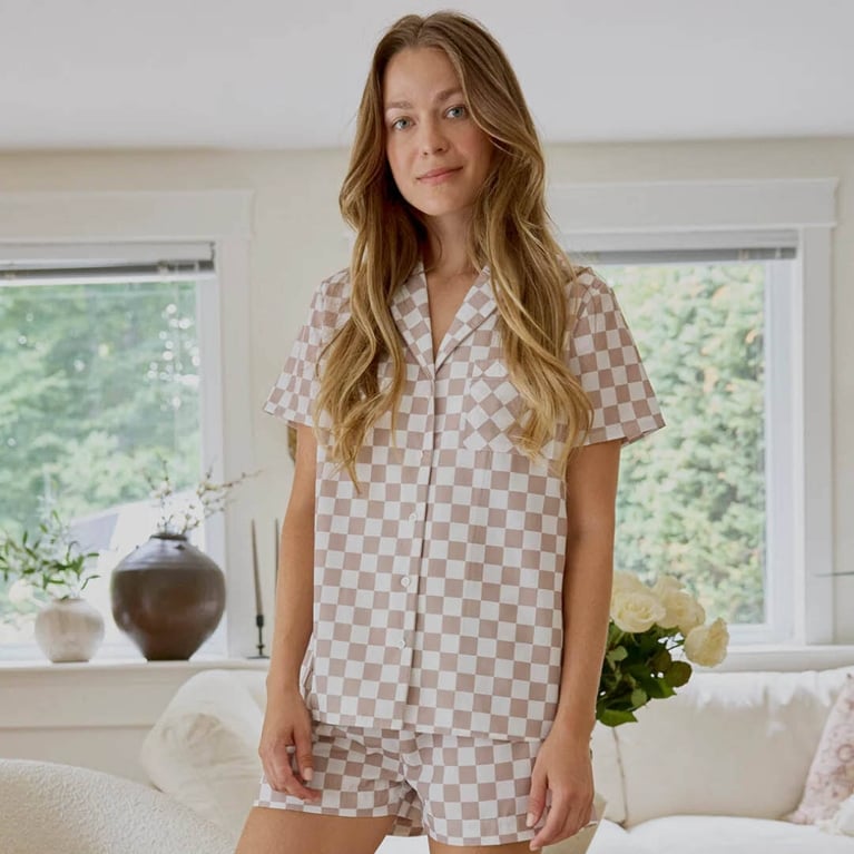 A model wearing the Petit Lem Taupe Checkerboard Poplin Women's Summer Sleep Set for an article about the best purchases editors picked for April 2026