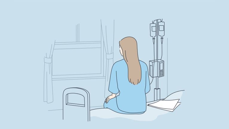 A man and a woman in a hospital room ahead of surgery, for a story about a Canadian woman travelling to the U.S. for endometriosis surgery.