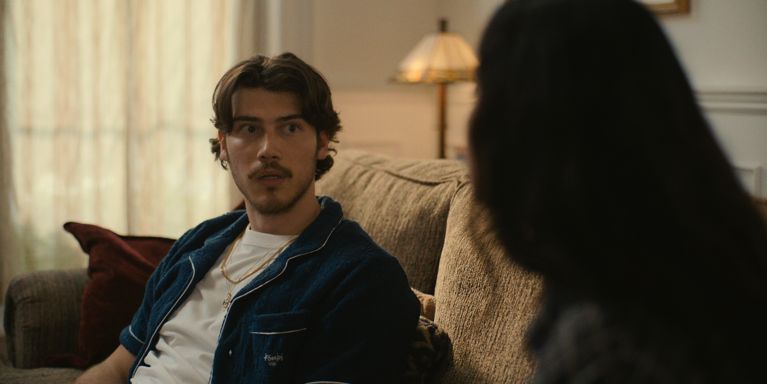 A photo of a man sitting on the couch used in a post about dan levy's big mistakes