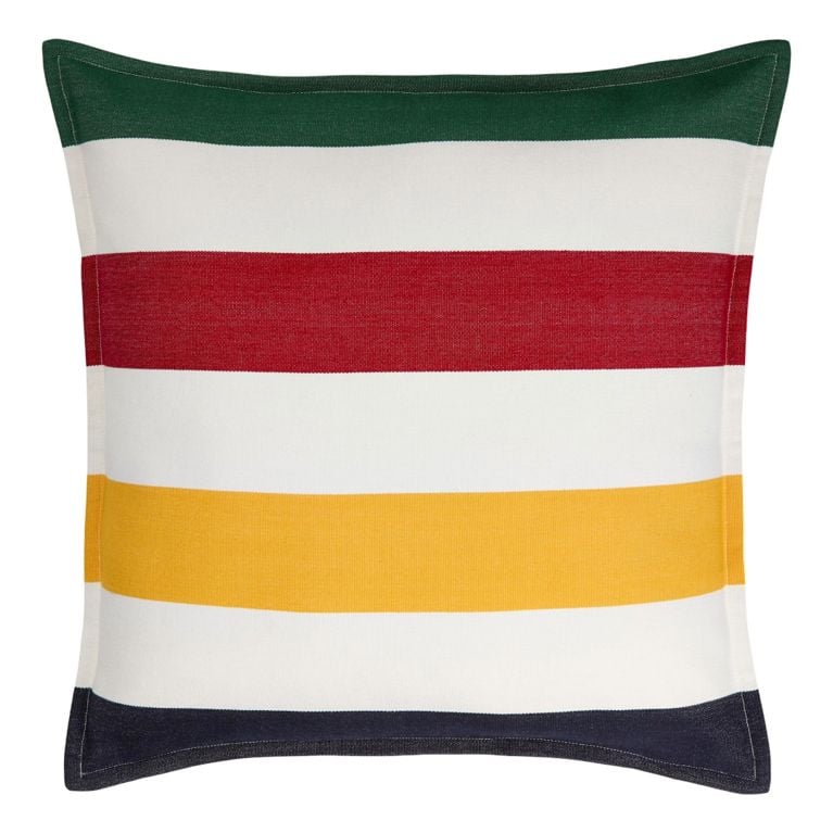 A Hudson's Bay Canadian Tire Summer Collection '26 Outdoor Accent Cushion with green, red, white, yellow and navy blue stripes for an article about the new collection