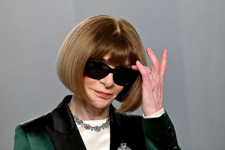 A photo of a woman with a bob and black sunglasses.