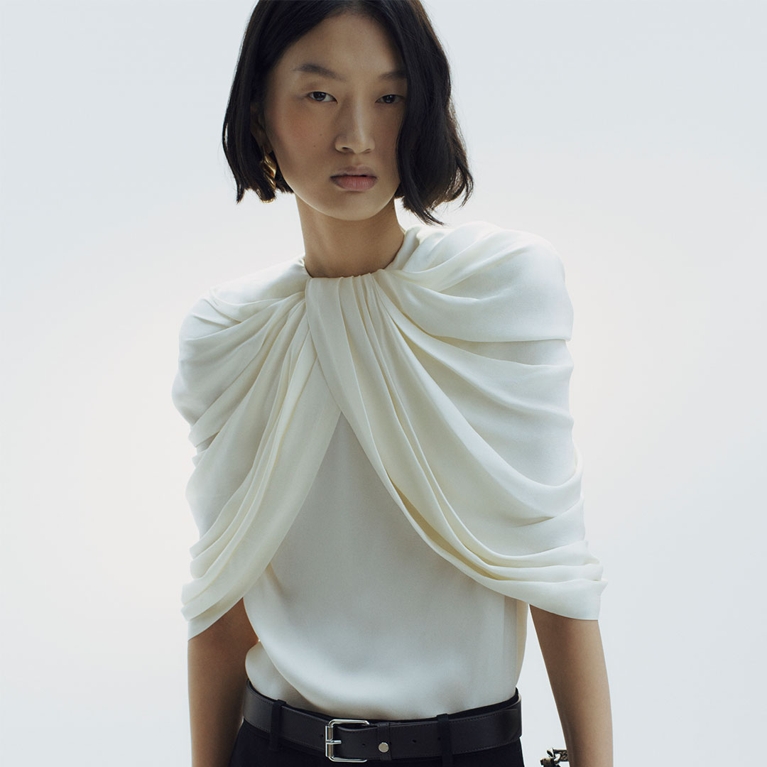 A white drapey top from the Stella McCartney H&M 2026 collection.