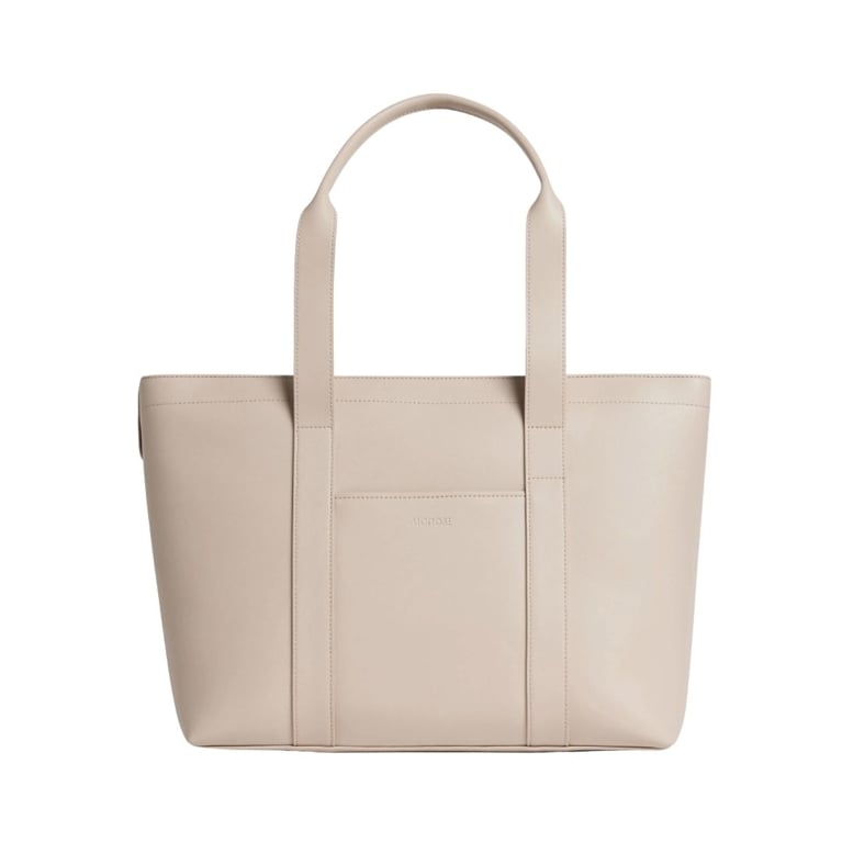A Monos Metro Tote in the shade Ivory made with Vegan Leather for an article about 12 structured tote styles that do it all