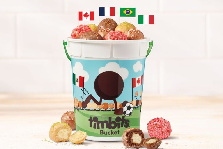 An image of plastic bucket full of tim hortons timbits new flavours.