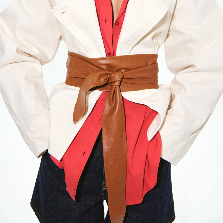 A tan wide belt from the Hailey Bieber Mango collection.