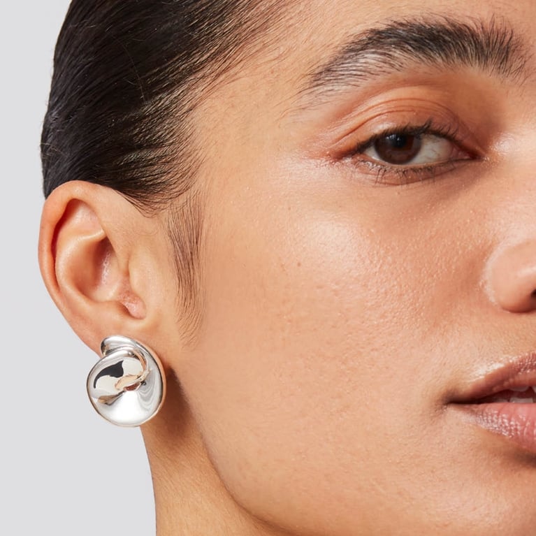 A pair of Jenny Bird Rio Button Earrings in the shade silver for an article about Mother's Day gifts from Canadian brands.