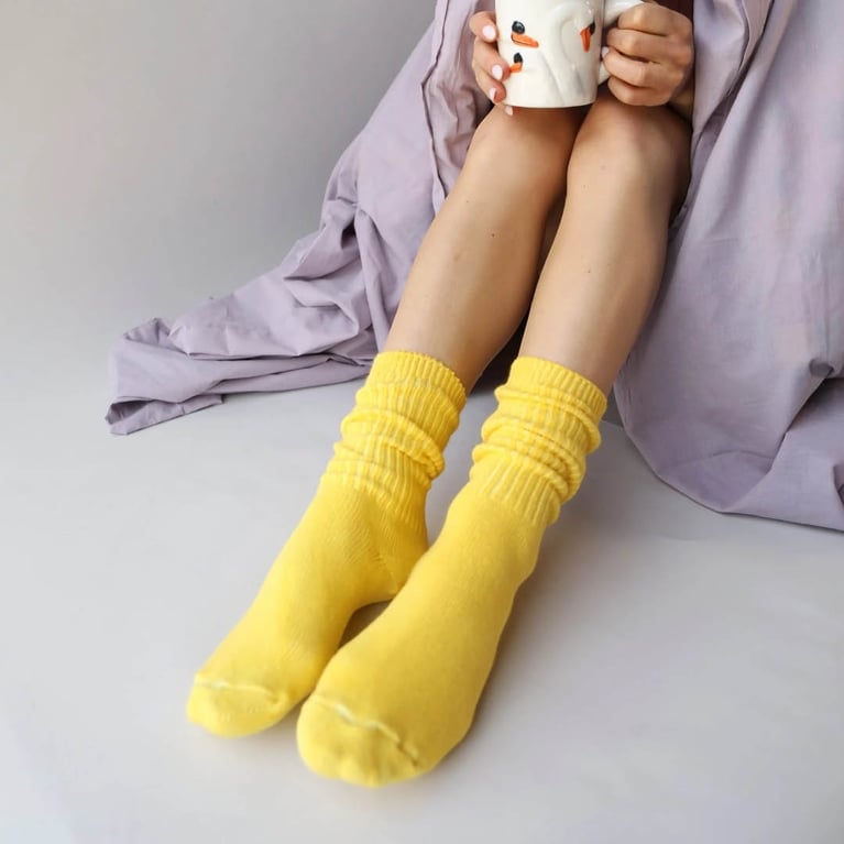 A model wearing yellow OkayOk Dyed Cotton Socks for an article about Mother's Day gifts from Canadian brands.