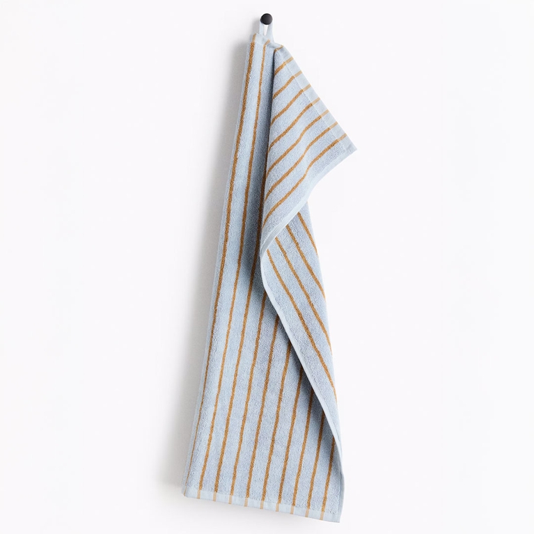 A blue and yellow H&M Striped Hand Towel for an article about the best Mother's Day gifts.