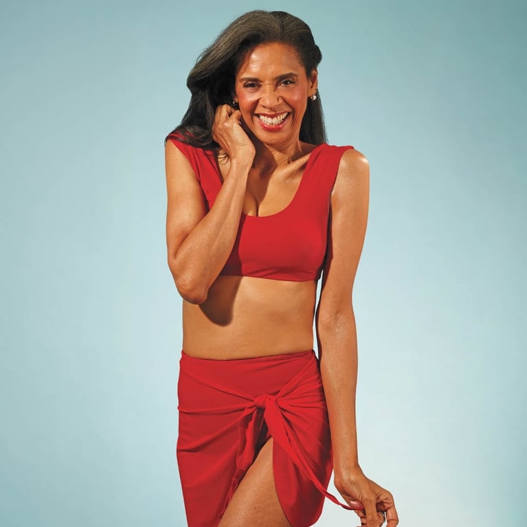 A model wearing a red Knix bikini and cover-up skirt for an article about the best Canadian swimsuits.