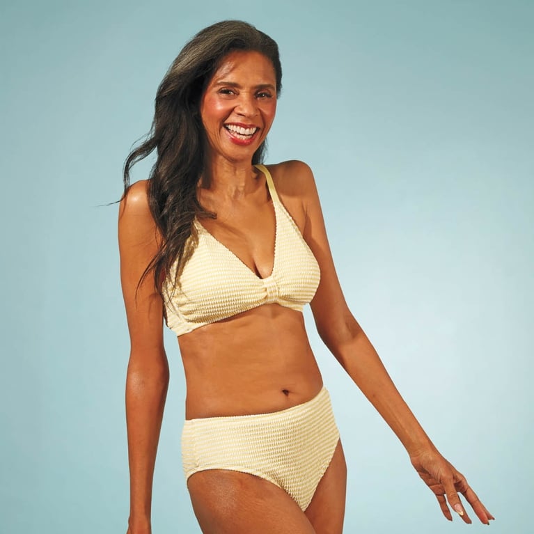 A model wearing a yellow La Vie En Rose bikini for an article about the best Canadian swimsuits.